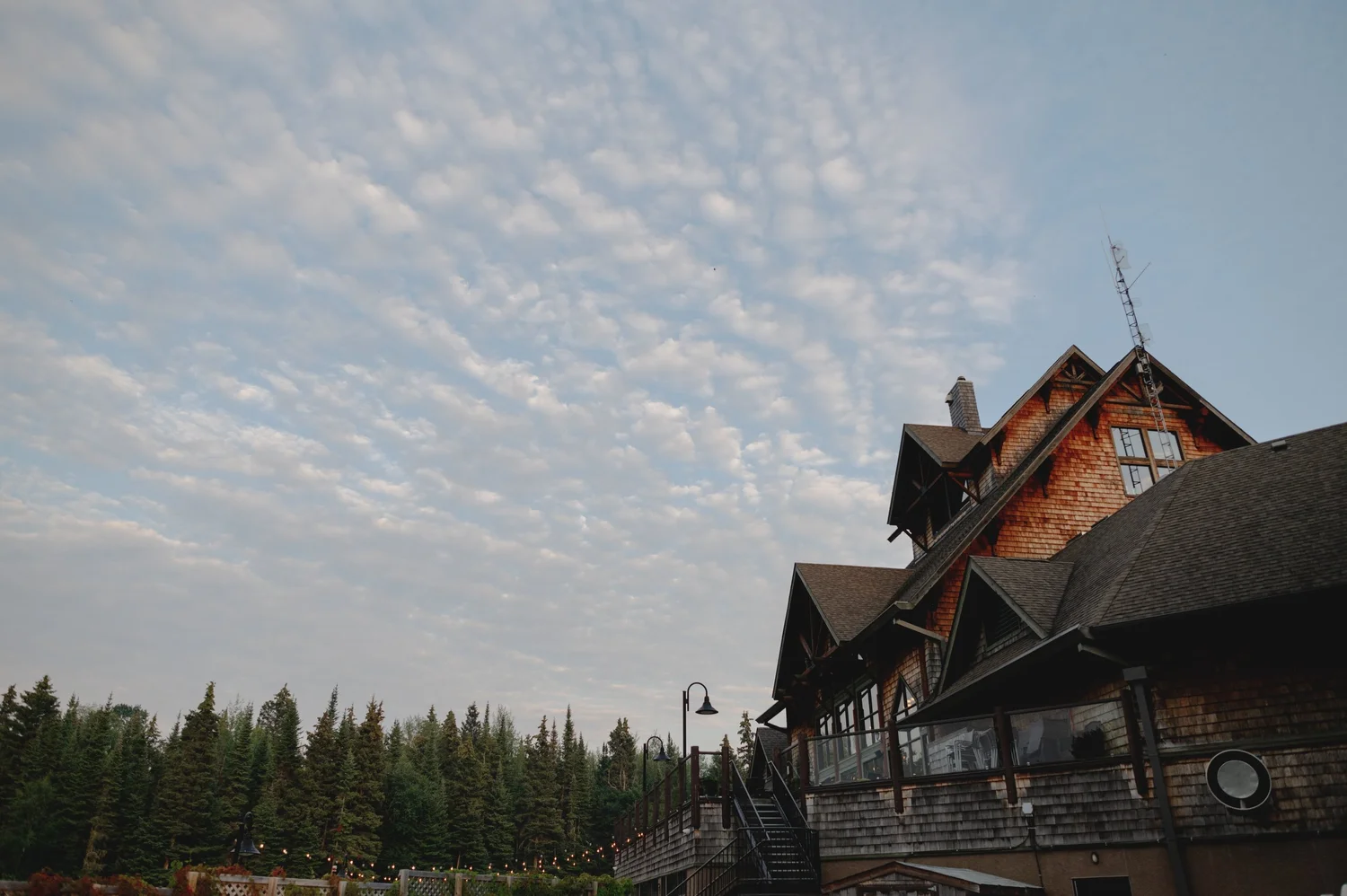 The lodge at Elk Ridge Resort at dusk with string lights along the deck