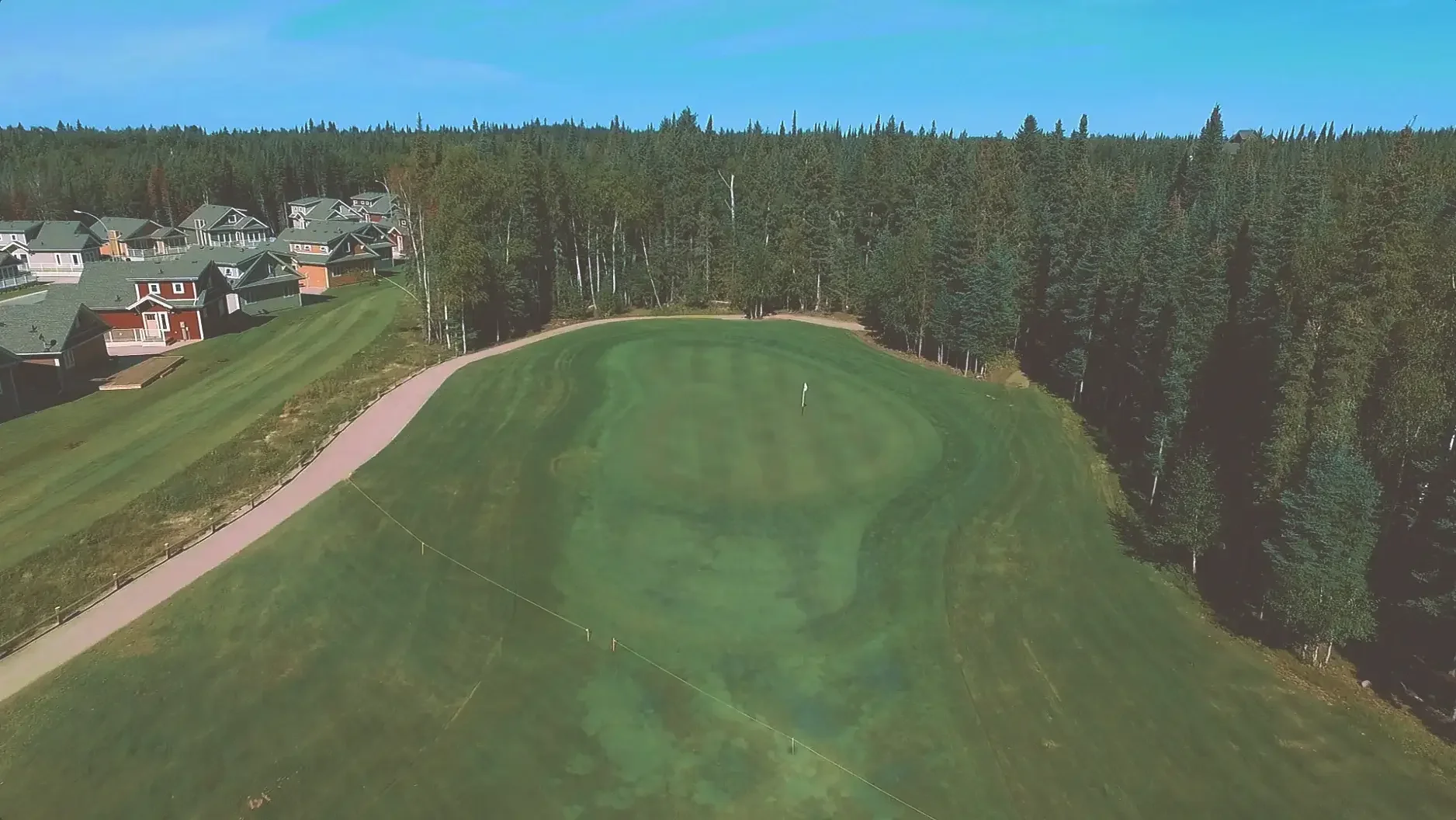 Aerial view of the ninth hole on the Aspen course at Elk Ridge Resort, the closing green set among the trees.