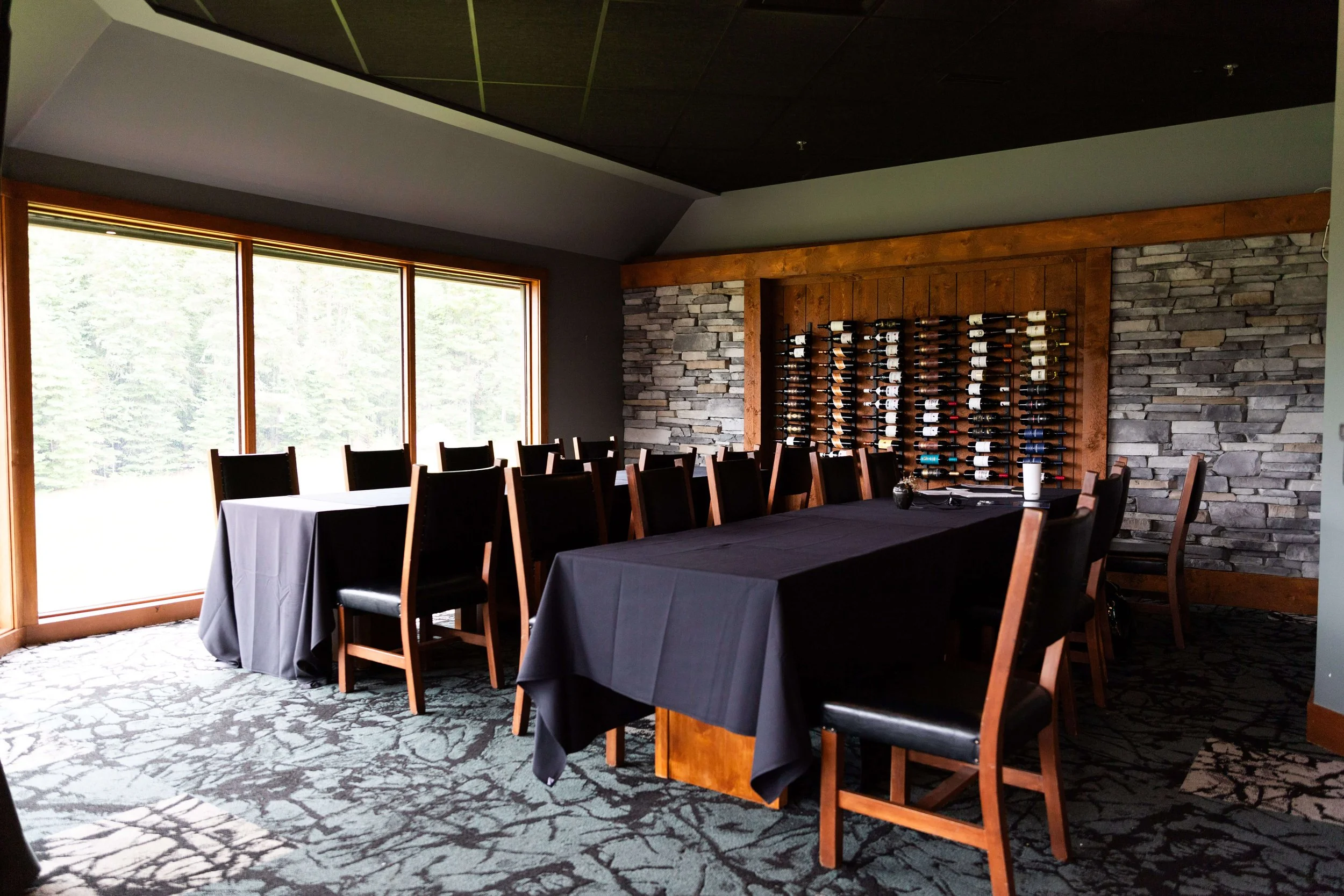 Interior of a dining area with dark tables and warm lighting