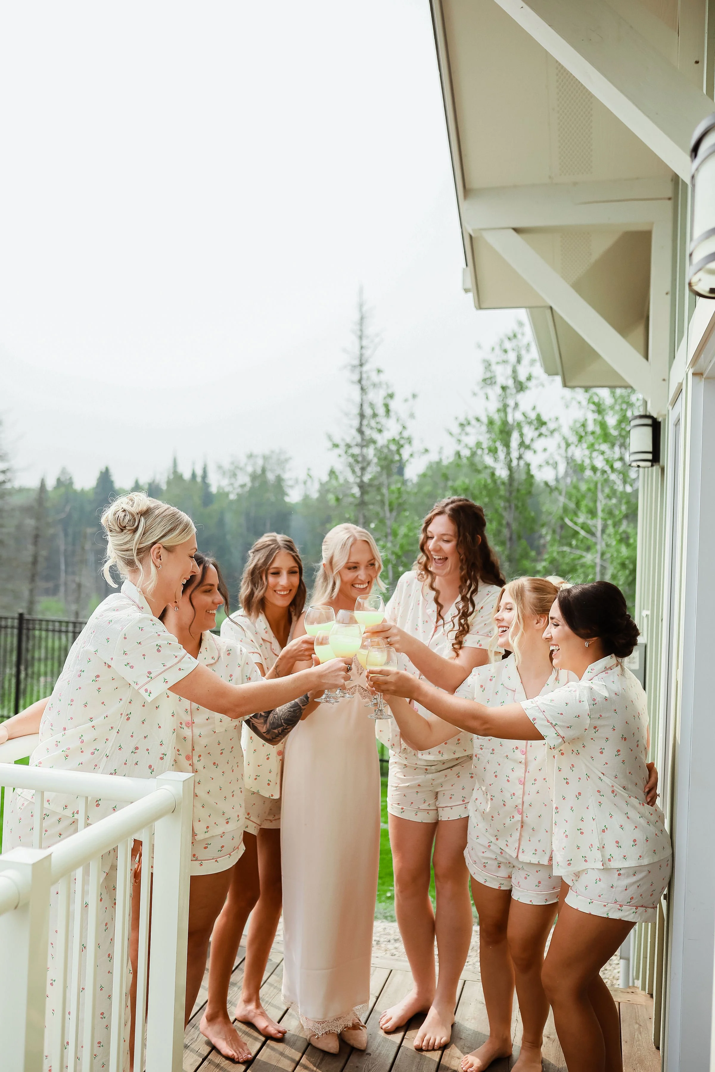 A group of women in pajamas celebrating together in a suite