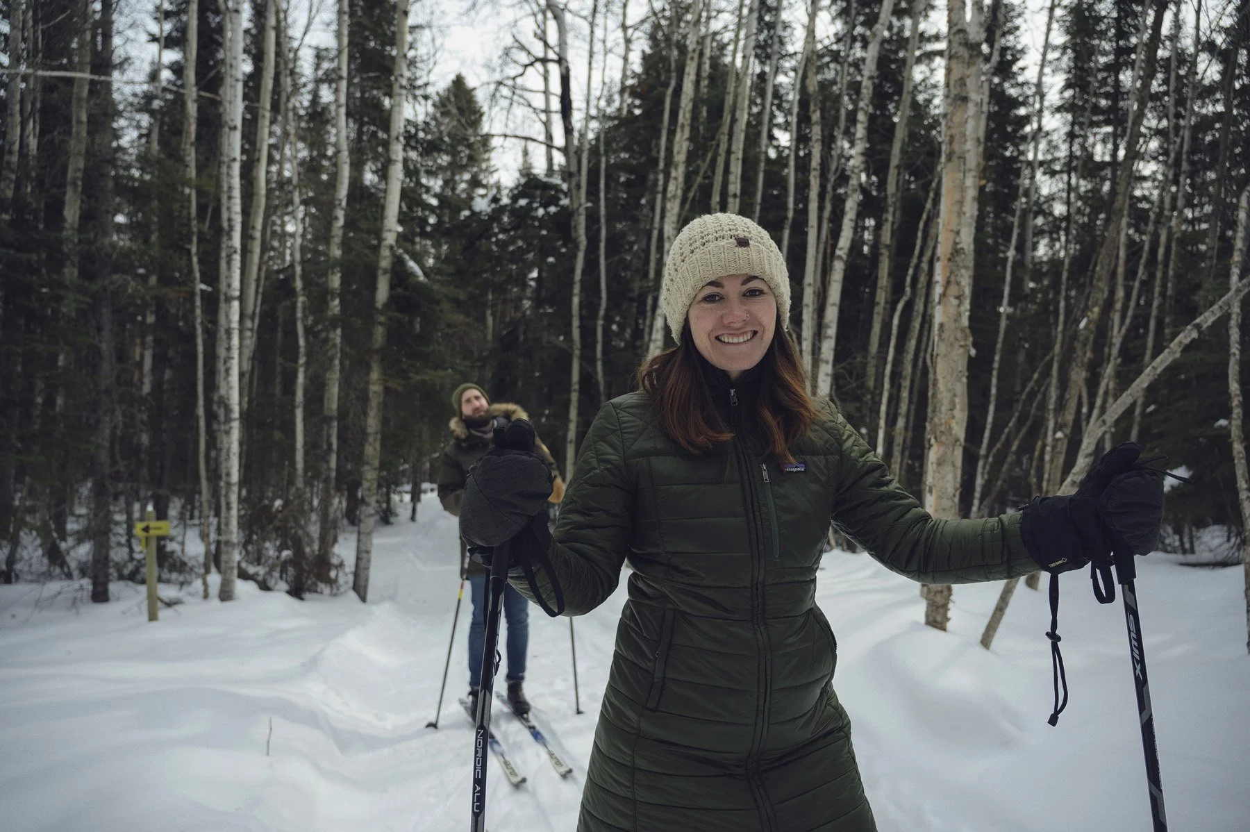 Two women snowshoeing in a snowy forest