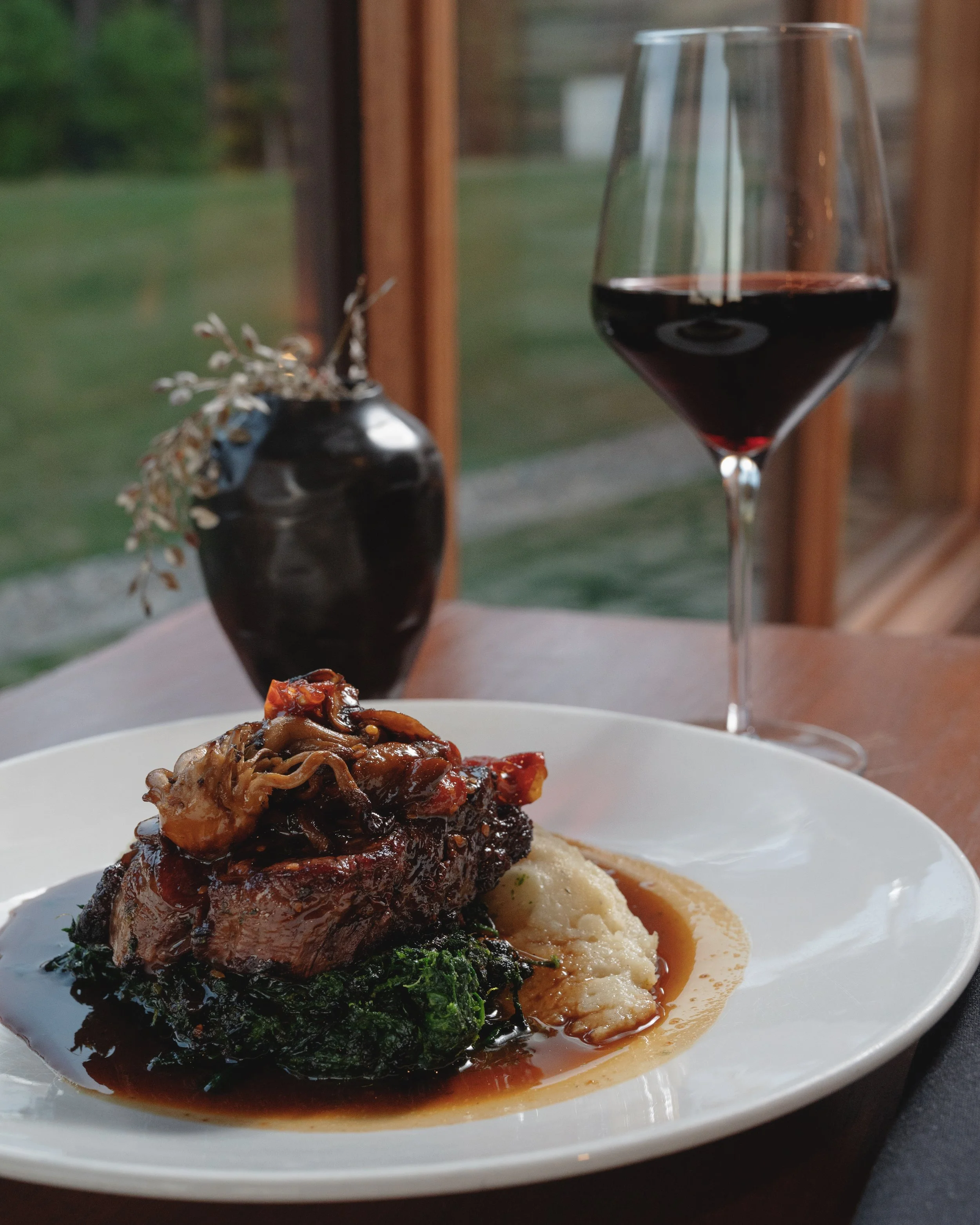 A plate with a serving of mashed potatoes and a chef-prepared entree