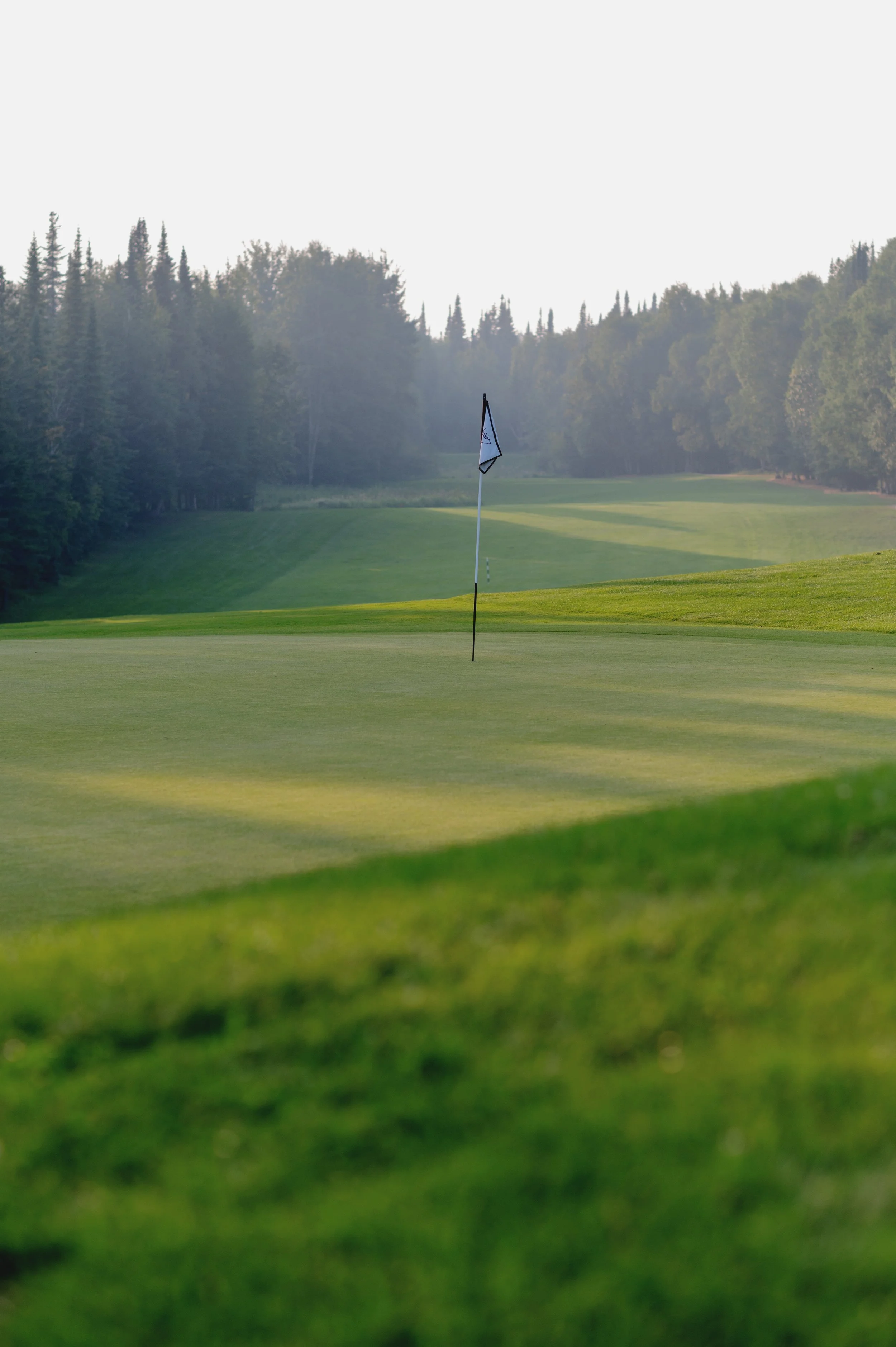 Championship golf course at Elk Ridge Resort, with a fairway framed by boreal forest