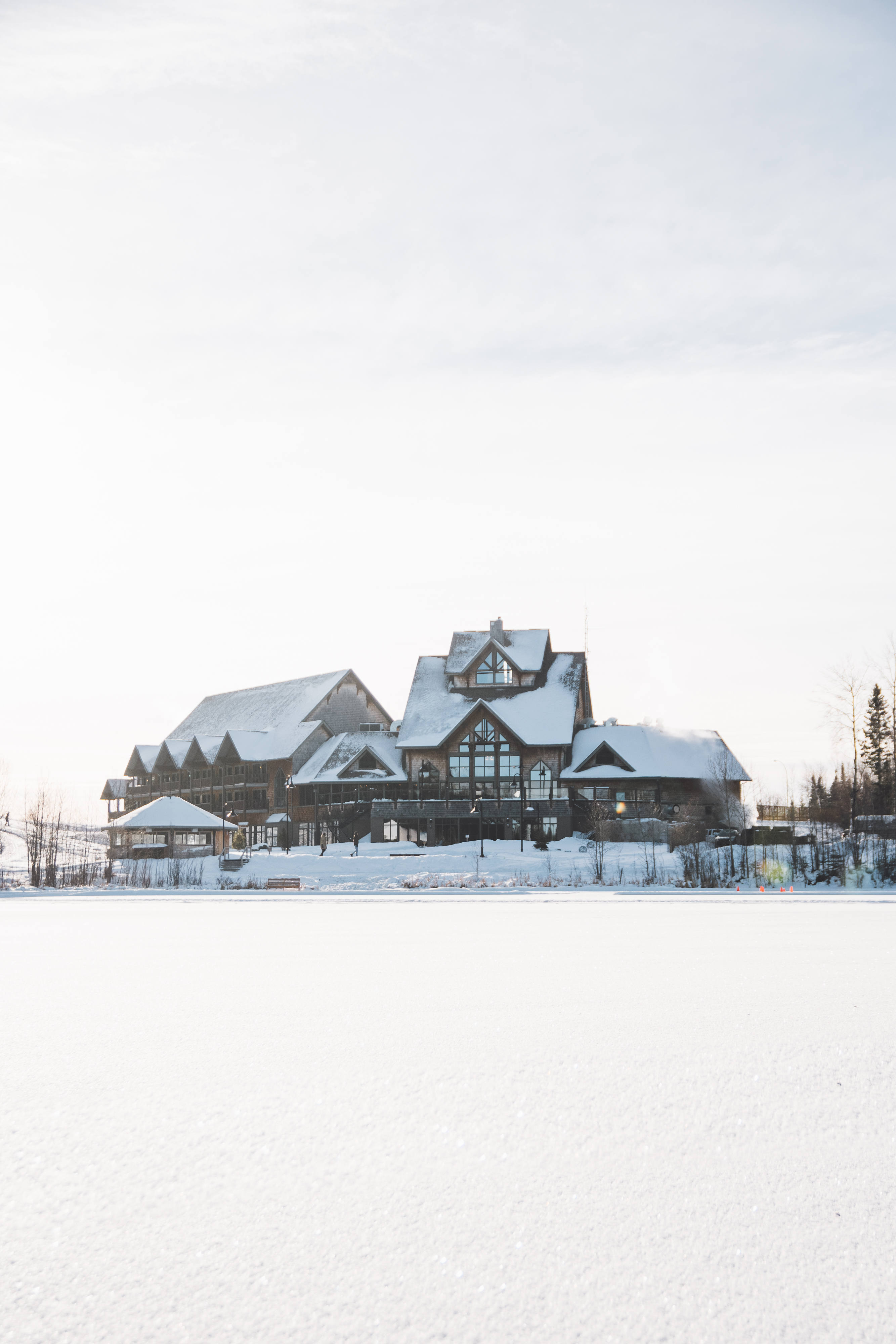 The Lodge at Elk Ridge Resort in winter, seen across a frozen, snow-covered lake
